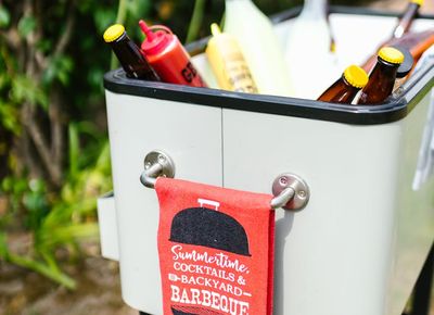 A water bottle and a towel next to a window.